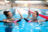 Multiracial couple attending water aerobics class in a swimming pool